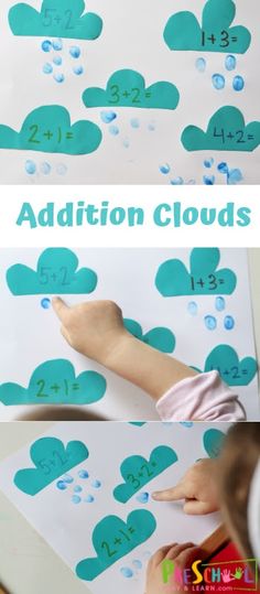 a child's hand is drawing on the clouds with blue paper