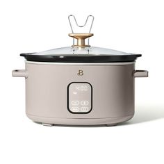 an electric crock pot with the lid open on a white background, it is also used to cook food