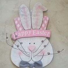 a wooden sign that says happy easter with an image of a bunny wearing a bow tie