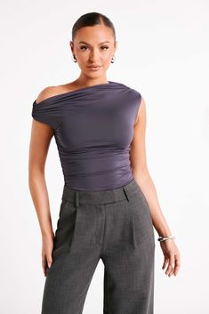 Perfect from all angles.ALAYNA is an asymmetrical top with a straight-cut neckline and strategic ruching. Sewn from a custom blend of elastane and recycled nylon, its stretchy fabrication offers a fairly bodycon fit that highlights your curves. The ruching around the waist and arms further shapes and elongates the body, creating a universally flattering silhouette. Fresh and unique, this seasonal must-have can be worn as a solo feature or layered with a textured blazer. Complete the contemporary Asymmetrical Top Outfit, Functional Wardrobe, Womens Basic Tops, Ruched Top, Denim Maxi Skirt, Asymmetrical Tops, Womens Basic, Online Tops, Basic Tops