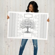 a woman holding up a large family tree poster