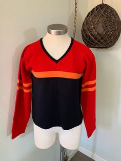 Vintage 1980s Sweater ~ Black, Red And Orange Stripped Pullover, V Neck, Size Large ~ Great Quality And Condition, USA I will be mailing this Priority Mail And First Class International. Measurements Bust ~ 36 Inch Shoulder To Shoulder ~ 16 Inch Waist ~ 36 Inch Sleeve ~ 22 Inch Length ~ 21 Inch Winter Red Tops With Contrast Stripes, Red Retro Winter Tops, Retro Red Tops For Winter, Red Tops With Contrast Stripes For Winter, Vintage Red Fall Sweater, Retro Fall Tops With Contrast Stripes, Retro Tops With Contrast Stripes For Fall, Vintage Red Top For Winter, Vintage Red Tops For Winter