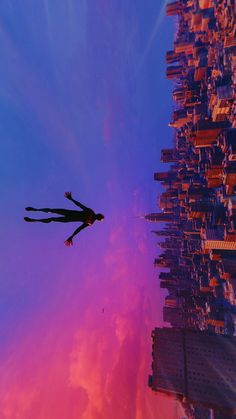 a person is flying through the air in front of a cityscape with tall buildings