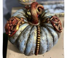 a decorative pumpkin sitting on top of a table