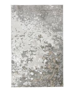 a gray and white rug with lots of dirt on it