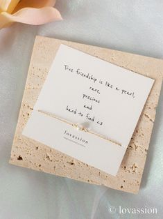 a card with a message on it next to a flower