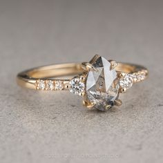 a yellow gold engagement ring with an oval cut diamond