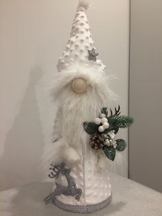 a white christmas hat on top of a table next to a deer figurine