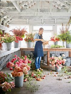 a woman is working in a flower shop