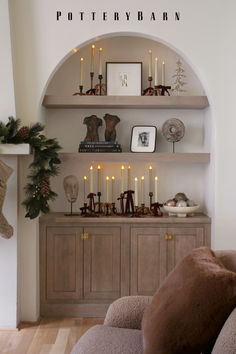 a living room filled with furniture next to a fire place and christmas decorations on top of shelves