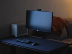 a computer monitor sitting on top of a desk next to a keyboard