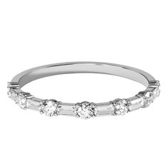 a white gold wedding band with five stones on the side and four baguetts at the bottom