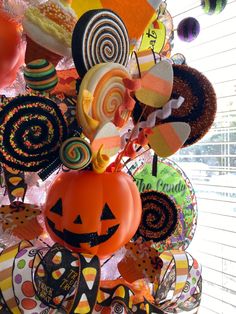 a halloween decoration with candy, candies and pumpkins hanging from it's side