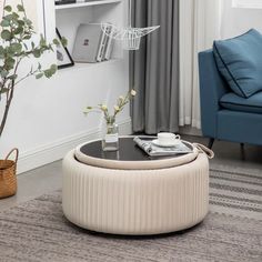 a living room with a couch, coffee table and bookshelf in the corner