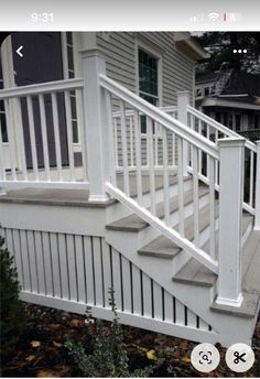 an image of a white railing on a house's front porch with stairs leading up to it