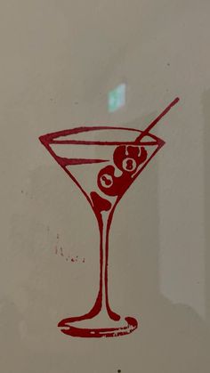 a drawing of a martini glass with an olive in it