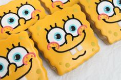 some decorated cookies are on a white table with polka dots and eyeballs in the shape of spongebob