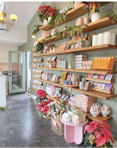 a store with shelves filled with lots of flowers and books on it's sides