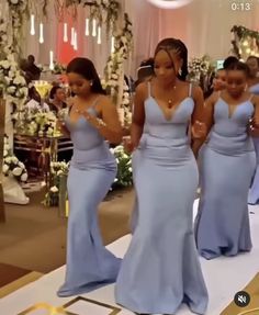 the bridesmaids are getting ready to walk down the aisle in their blue dresses