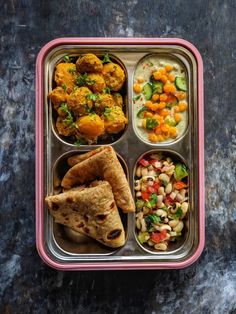 a bento box filled with different types of food on top of a black table