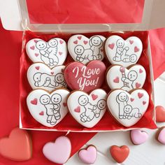 heart shaped cookies in a box with i love you written on them