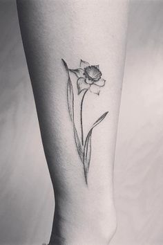 a single flower tattoo on the ankle