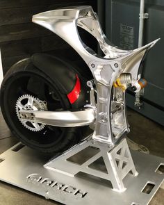 a motorcycle is shown on display in a showroom with its wheels and rims