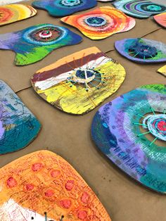 colorful paper plates are laid out on the ground to be used for art projects and crafts