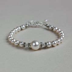 Vintage-style beaded bracelet featuring Swarovski pearls and crystals combined with sparkly rhinestone spacers. Perfect for any occasion, weddings and parties or as a gift.  Please note that although I take a great care to keep the colours on the photographs as close to reality as possible, they may look slightly different on different monitors. Materials used:  Swarovski pearls, white (4 mm, 6 mm, and 10 mm), Swarovski crystals, clear (4 mm), rhinestone spacers, silver and antique silver colour Luxury Wedding Pearl Chain Beaded Bracelets, Wedding Pearl White Beaded Bracelets, Formal White Crystal Pearl Bracelet, White Crystal Pearl Bracelet For Formal Occasions, Pearl White Beaded Bracelet For Wedding, Wedding Pearl Bracelet With Beaded Details, Formal White Beaded Crystal Bracelet, White Pearl Crystal Bracelet For Wedding, White Beaded Crystal Bracelet For Formal Occasions