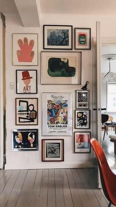 there are many framed pictures on the wall