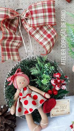 a christmas wreath with a doll and pine cones