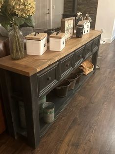 a large wooden table topped with lots of pots and pans on top of it