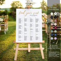 a wedding seating chart on an easel in the grass with flowers and greenery