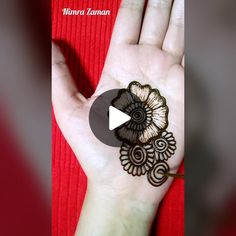 a woman's hand with henna on it and the video is being displayed