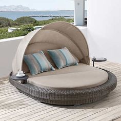 an outdoor day bed on a wooden deck