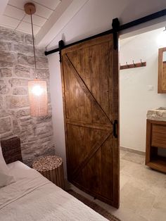 a bedroom with stone walls and wooden doors