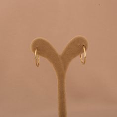 Our 14K Gold Skinny Hoop Earrings offer a timeless design, combining sleek elegance with everyday functionality. These classic hoops are crafted from genuine 14K solid gold, providing durability and a lasting shine that will complement any wardrobe. With an outside diameter of 21.5mm and an inside diameter of 19mm, these earrings are designed to be lightweight and comfortable, making them perfect for daily wear or special occasions. The slender thickness of 1.65mm ensures they remain subtle yet noticeable. Key Features: Sleek Design: Features a slender profile, perfect for adding a touch of elegance to any outfit. High-Quality Material: Crafted from genuine 14K solid gold, ensuring both elegance and long-lasting wear. Lightweight Comfort: Designed with a thickness of 1.65mm for a comfortab Classic 14k Gold Hypoallergenic Hoop Earrings, Classic 14k Gold Hoop Earrings, Classic Rose Gold Hoop Earrings, Small Hoop Yellow Gold Classic Earrings, Classic Small Hoop 14k Gold Earrings, Classic Small Hoop Earrings In Yellow Gold, Classic Hoop Earrings With Simple Design, Classic Small Hoop Earrings For Everyday, Classic Hoop Earrings For Everyday Luxury