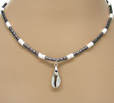 Black Glass White Puka Shells Necklace Silver Cowrie Shell Cowry Pendant Beach 18 Inches 7088-48 #18Inches #WomensNecklace #beach #BlackAndWhite #sup #surfer #VSCO #SeaShell #PukaShell #hematite Silver Beaded Jewelry For Vacation, Beach Silver Single Strand Necklace, Silver Single Strand Necklace For Beach, Silver Spacer Beads Jewelry For Beach, Silver Single Strand Jewelry For Beach, Beach White Silver Beaded Jewelry, Beaded Silver Strand Jewelry, Shells Necklace, Shell Beads Necklace