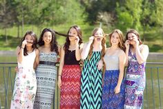 a group of young women standing next to each other on a bridge with their mouths open