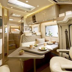 the interior of an airplane with tables, chairs and trays on each side of the table