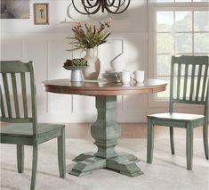 a dining room table and chairs with different color swatches on the wall behind them