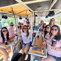 a group of women sitting on top of a bus