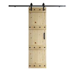 an open wooden door with black hardware on the bottom and two bars hanging from it