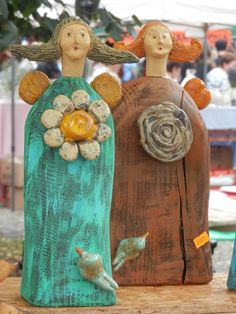 three wooden statues sitting on top of a table