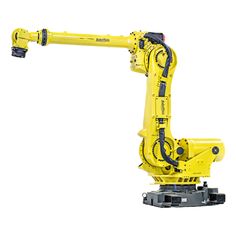 a yellow robot that is sitting on top of a table and has its arm extended