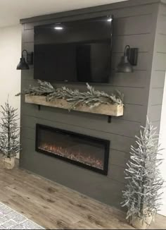 a living room with a large flat screen tv mounted on the wall above a fireplace