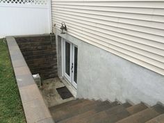 an outside view of a house with steps leading up to the front door and side entrance