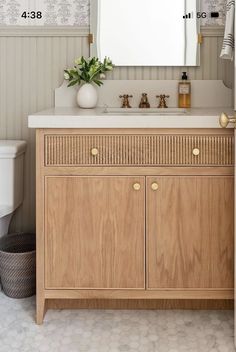 a bathroom with a sink, mirror and toilet