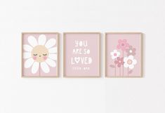 three pink and white wall art prints with flowers on the bottom, you are so loved little one