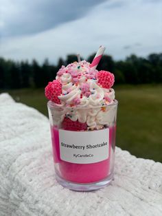 a cup filled with cake and sprinkles on top of a blanket